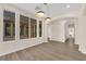 Open dining area featuring natural light, modern pendant lights, wood-look floors, and easy access to backyard at 177 Rocky Star St, Henderson, NV 89012