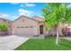 Inviting single-story home featuring a well-manicured lawn and two-car garage under a bright blue sky at 177 Rocky Star St, Henderson, NV 89012