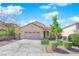 Attractive single-story home featuring a two-car garage, manicured lawn, and a welcoming front entrance at 177 Rocky Star St, Henderson, NV 89012