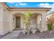 Welcoming front porch with decorative planters and a charming arched entryway leading to the front door at 177 Rocky Star St, Henderson, NV 89012