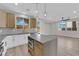 Modern kitchen featuring stainless steel appliances, an island, and a seamless flow into the living area at 177 Rocky Star St, Henderson, NV 89012
