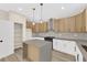 Well-lit kitchen with white and wood cabinets, gray countertops, and stainless steel appliances at 177 Rocky Star St, Henderson, NV 89012