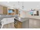 Bright, open kitchen with light wood floors, stainless appliances, and an island with breakfast bar at 177 Rocky Star St, Henderson, NV 89012