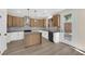 Modern kitchen featuring stainless steel appliances, granite countertops, an island, and wood-look floors for a sleek design at 177 Rocky Star St, Henderson, NV 89012