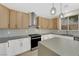Stylish kitchen with gray countertops, modern appliances, and light wood cabinets at 177 Rocky Star St, Henderson, NV 89012
