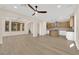 Spacious living area with wood-look floors, modern lighting, seamlessly connecting dining and kitchen spaces at 177 Rocky Star St, Henderson, NV 89012