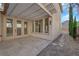 Back patio with tile flooring, covered pergola, and large sliding glass doors at 177 Rocky Star St, Henderson, NV 89012
