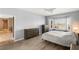 Neutral bedroom with hardwood floors, large windows, and furniture at 2069 Colvin Run Dr, Henderson, NV 89052