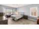 Well-lit bedroom with hardwood floors, neutral walls, and a queen-sized bed at 2069 Colvin Run Dr, Henderson, NV 89052