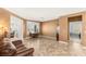 Cozy living room featuring neutral walls, tile floors, and ample natural light at 2069 Colvin Run Dr, Henderson, NV 89052