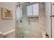 Modern bathroom with glass shower, marble-style tiling, and decorative accents like a perfume bottle artwork at 2074 Sutton Way, Henderson, NV 89074
