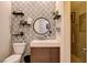 This bathroom features decorative tile walls, and a modern sink and vanity combo at 2074 Sutton Way, Henderson, NV 89074
