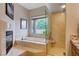 Bathroom with walk-in shower, soaking tub, and granite countertops at 2074 Sutton Way, Henderson, NV 89074