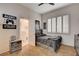 Bedroom with carpet floors, ceiling fan, closet, and an open ensuite bathroom; features a small gaming-themed decor at 2074 Sutton Way, Henderson, NV 89074