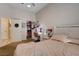 Bright bedroom featuring a closet and vanity with illuminated mirror and a bed with a soft pink patterned cover at 2074 Sutton Way, Henderson, NV 89074