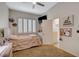 Inviting bedroom with carpeted floor, shuttered window, modern vanity, and open door to an ensuite bathroom at 2074 Sutton Way, Henderson, NV 89074