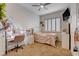 Cozy bedroom featuring light color walls, ceiling fan, shutters, carpet floors and a vanity with illuminated mirror at 2074 Sutton Way, Henderson, NV 89074