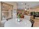 Bright dining area with stylish table and chairs, seamlessly connected to kitchen with bar seating and modern appliances at 2074 Sutton Way, Henderson, NV 89074