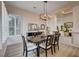 This dining room has bright light and a modern chandelier above a large table at 2074 Sutton Way, Henderson, NV 89074