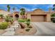 Charming single-story home featuring a well-manicured front yard with beautiful desert landscaping and a two-car garage at 2074 Sutton Way, Henderson, NV 89074