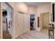 Neutral hallway with white trim, closet and views to other rooms; features light wood floors and decor at 2074 Sutton Way, Henderson, NV 89074