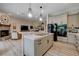 Bright, open-concept kitchen featuring a marble-top island, modern appliances, and seamless flow into the living area at 2074 Sutton Way, Henderson, NV 89074