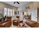 This living room features comfortable seating, a basketball hoop, and a ceiling fan at 2074 Sutton Way, Henderson, NV 89074