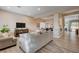 Spacious living room featuring neutral tones, wood laminate floors, flows into the dining area at 2074 Sutton Way, Henderson, NV 89074