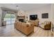 Bright and airy living room with direct access to the pool area, featuring a cozy fireplace and comfortable seating at 2074 Sutton Way, Henderson, NV 89074