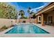 Backyard pool with a water feature, palm trees, patio, and lounge area at 2074 Sutton Way, Henderson, NV 89074