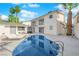 Private backyard retreat with a uniquely shaped pool, lounge chairs, manicured landscaping and mature palms at 2160 Pueblo Cir, Las Vegas, NV 89169