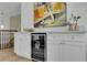 Chic upper level bar area includes wine cooler, stone countertop, swan hardware, and decorative accents at 2160 Pueblo Cir, Las Vegas, NV 89169