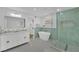 Bright bathroom featuring double vanity, soaking tub, and shower with stylish green tiling at 2160 Pueblo Cir, Las Vegas, NV 89169