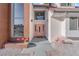 Inviting front entrance with a pink door, brick accents, and decorative flamingos at 2160 Pueblo Cir, Las Vegas, NV 89169
