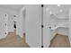 Bright hallway with wood floors, white walls, and closet space at 2160 Pueblo Cir, Las Vegas, NV 89169