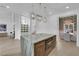 Modern kitchen with marble island, stainless steel appliances, and open layout to dining area at 2160 Pueblo Cir, Las Vegas, NV 89169