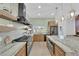 Modern kitchen with a spacious island, stainless appliances, and view to a brick fireplace feature at 2160 Pueblo Cir, Las Vegas, NV 89169