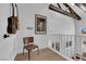 A mezzanine with guitars on the wall, a comfortable chair, and a view of the living room at 2160 Pueblo Cir, Las Vegas, NV 89169