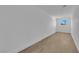 Neutral room features wood-look flooring, white walls, and a window offering natural light at 2160 Pueblo Cir, Las Vegas, NV 89169