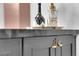 Close-up of wet bar cabinets, gold fixtures and marble counter at 2160 Pueblo Cir, Las Vegas, NV 89169