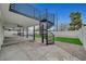 Backyard features a spiral staircase leading to a balcony, artificial turf, and a fenced pool area at 2521 Richfield Blvd, Las Vegas, NV 89102