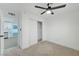 A bedroom with a ceiling fan, carpet, and a closet is next to a kitchen area at 2521 Richfield Blvd, Las Vegas, NV 89102
