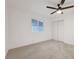 Bedroom featuring neutral carpeting, a ceiling fan, a window for natural light, and double door closet at 2521 Richfield Blvd, Las Vegas, NV 89102