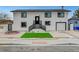 Two-story home showcasing a freshly painted white exterior, black trim, manicured front yard, and attached garage at 2521 Richfield Blvd, Las Vegas, NV 89102