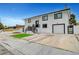 Two-story home showcasing a freshly painted white exterior, black trim, manicured front yard, and an attached garage at 2521 Richfield Blvd, Las Vegas, NV 89102