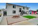 Two-story home showcasing a freshly painted white exterior, black trim, a manicured front yard, and driveway at 2521 Richfield Blvd, Las Vegas, NV 89102