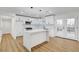 Modern kitchen featuring white cabinetry, a large quartz countertop island, stainless steel appliances, and French doors at 2521 Richfield Blvd, Las Vegas, NV 89102