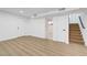 Spacious living room features modern laminate floors, white walls, and easy access to stairs and other rooms at 2521 Richfield Blvd, Las Vegas, NV 89102