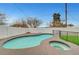 Backyard pool and spa featuring an artificial turf area, and a white fence at 2521 Richfield Blvd, Las Vegas, NV 89102
