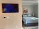Comfortable bedroom featuring a bed with pillows, a side table and artwork at 260 E Flamingo Rd # 228, Las Vegas, NV 89169